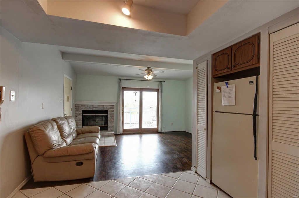 View from the kitchen into the living room, fireplace and deck door
