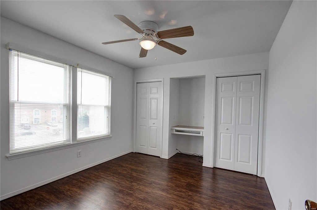 Second bedroom with two closets and a built-in desk